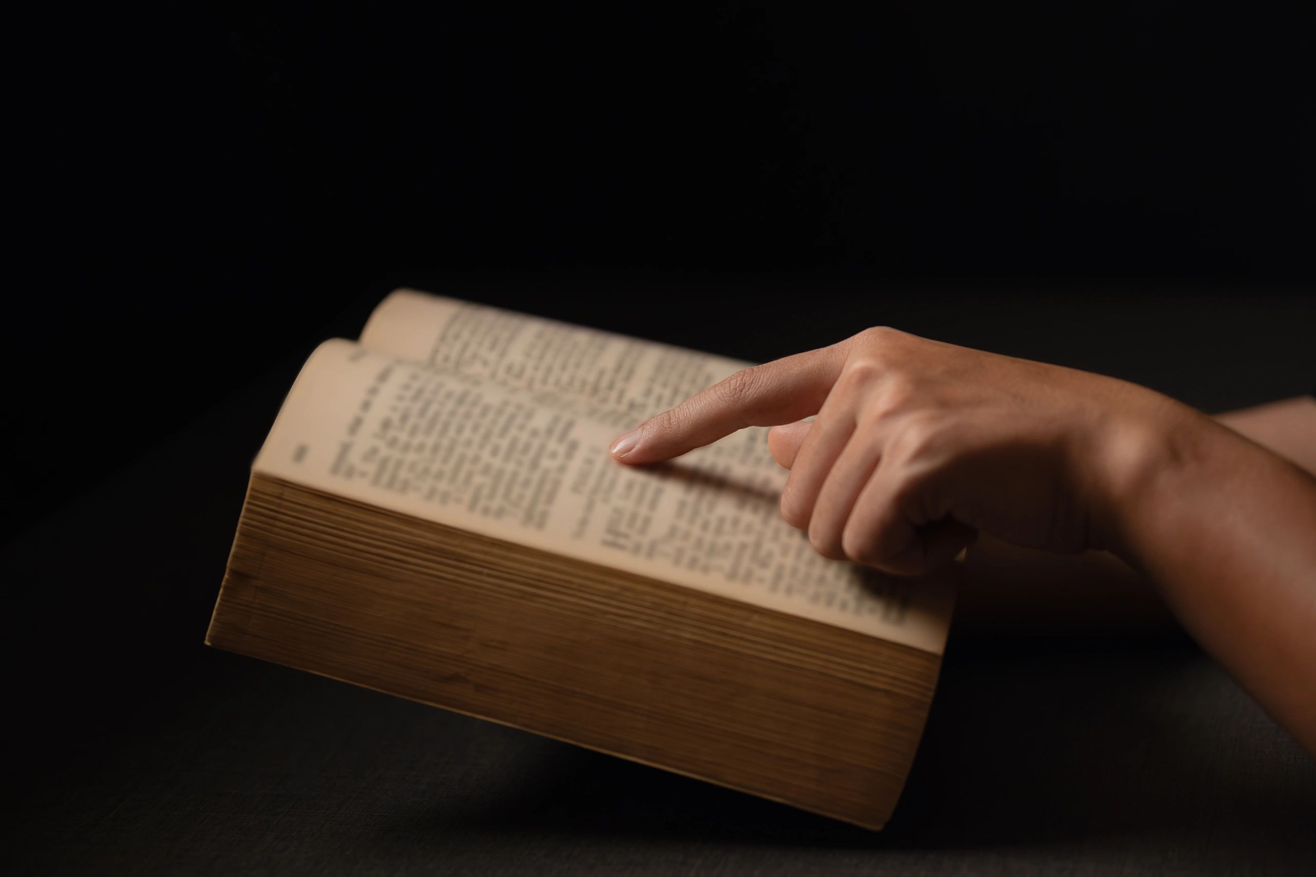Hands studying an open Bible